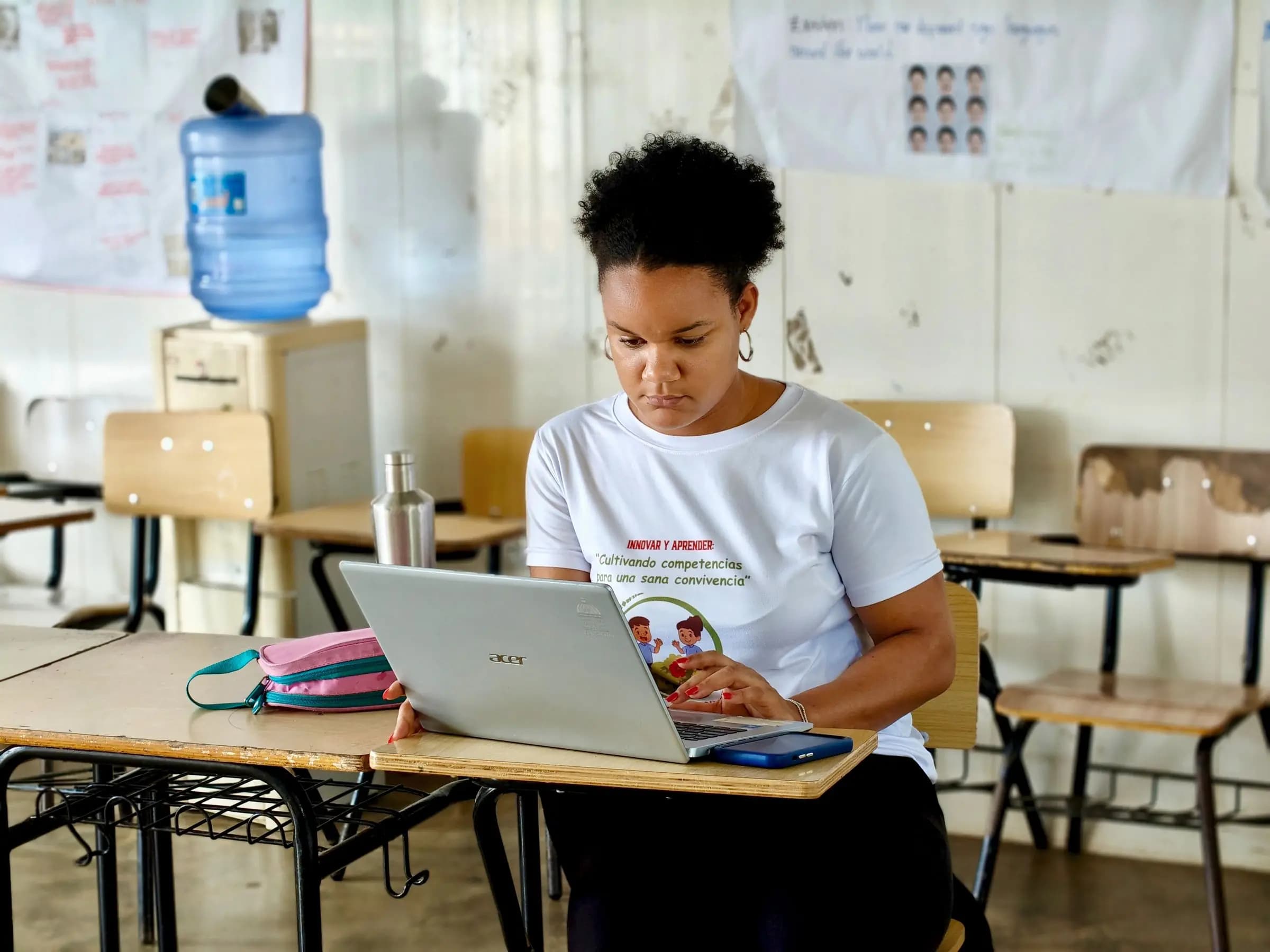 A woman working on a laptop at a desk