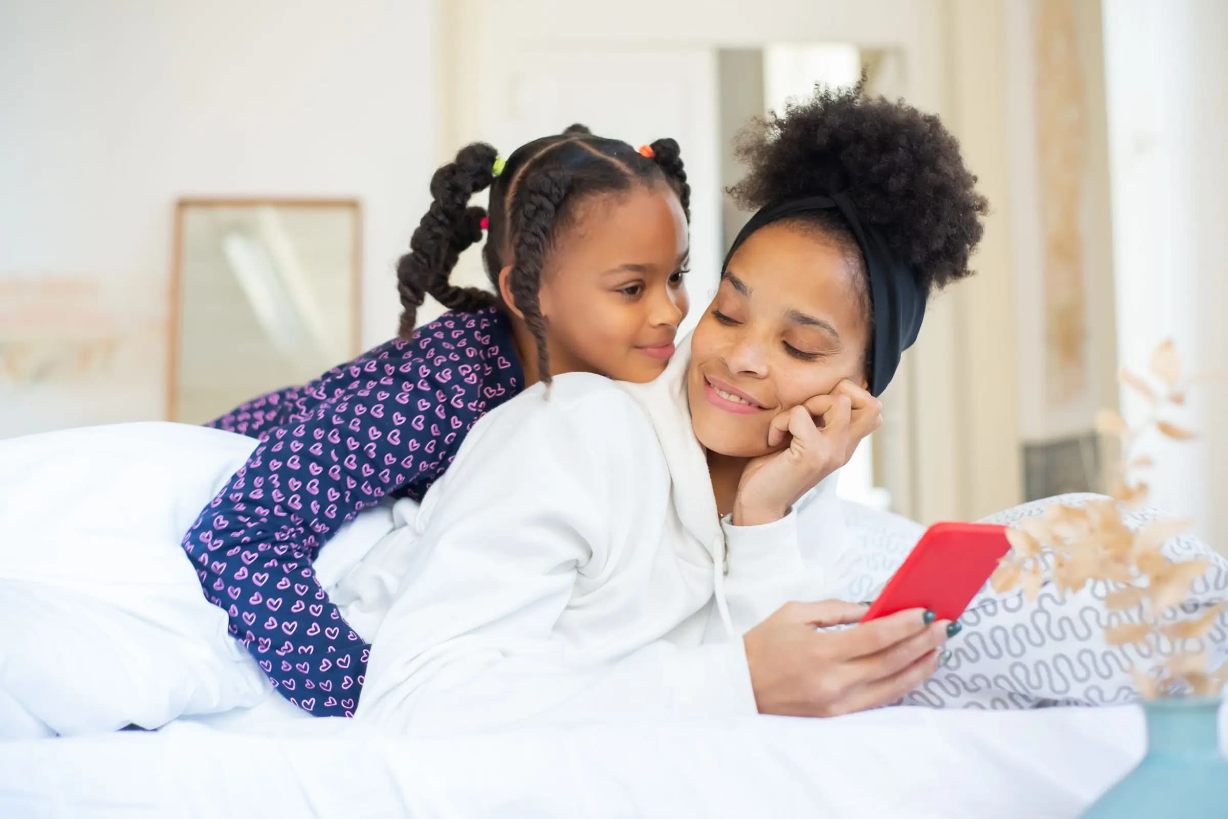 A mother and daughter looking at a phone together